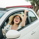 Young happy woman showing key of new car - Rental and buy new car concept - PhotoDune Item for Sale