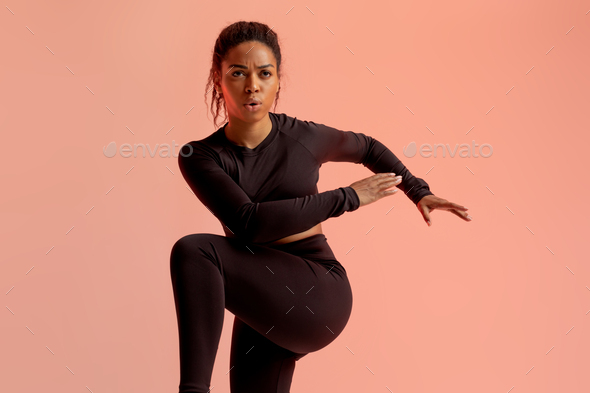 Sport exercises and healthy lifestyle. Portrait of black lady running and sprinting, lifting leg up