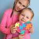 Sisters with pigtails look with smile at the camera holding the autism symbol - PhotoDune Item for Sale