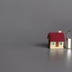 Toy house and padlock with copy space for text on grey background. - PhotoDune Item for Sale