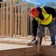 Contractor worker is hammering nail in the process of framing a new wooden house. - PhotoDune Item for Sale