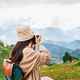 Young woman traveler taking a beautiful landscape at the mountains, Travel lifestyle concept - PhotoDune Item for Sale