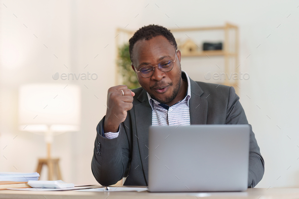 American African entrepreneur smile and use a mobile phone to check online order. Successful SME - Stock Photo - Images