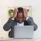 Tired American African business man in stress works with many paperwork document. migraine attack - PhotoDune Item for Sale