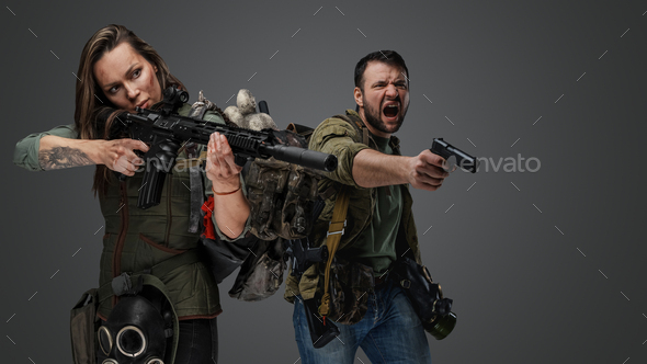 Mad man and woman in fight stance aiming rifle
