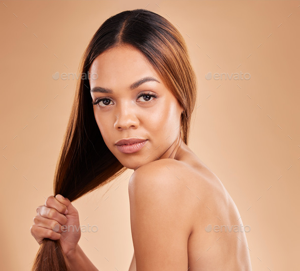 Woman, beauty and hair care portrait for growth and shine shampoo on a brown background. Aesthetic