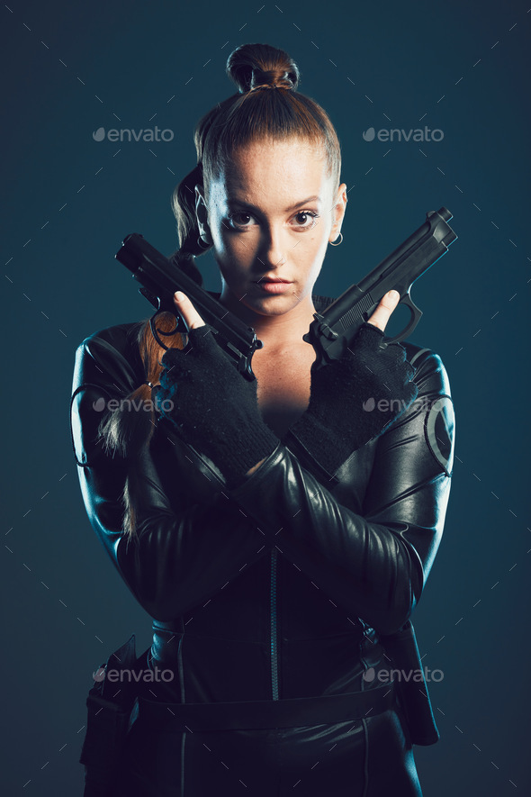 Woman, gun and assassin in studio portrait for costume, action or cyberpunk fashion. Girl, pistol a
