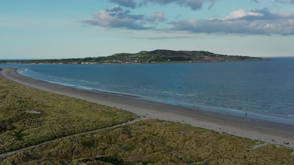 Howth peninsula on the horizon at golden hour. alt