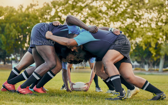 Scrum, sports and men playing rugby, catching a ball and preparing for a game on the field. Ready,