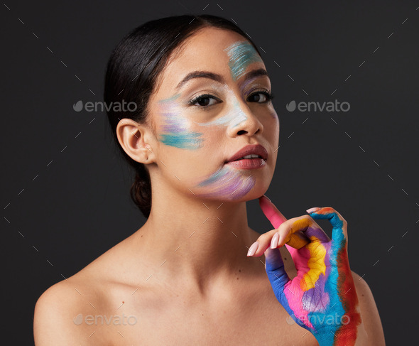 Woman, beauty and portrait with rainbow hand paint art on face in studio  with glow. Creative skin a Stock Photo by YuriArcursPeopleimages