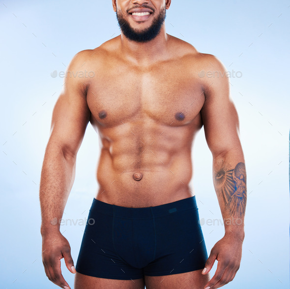 Black man in underwear, fitness and body with abs, healthy and active,  muscle and strong on blue ba Stock Photo by YuriArcursPeopleimages