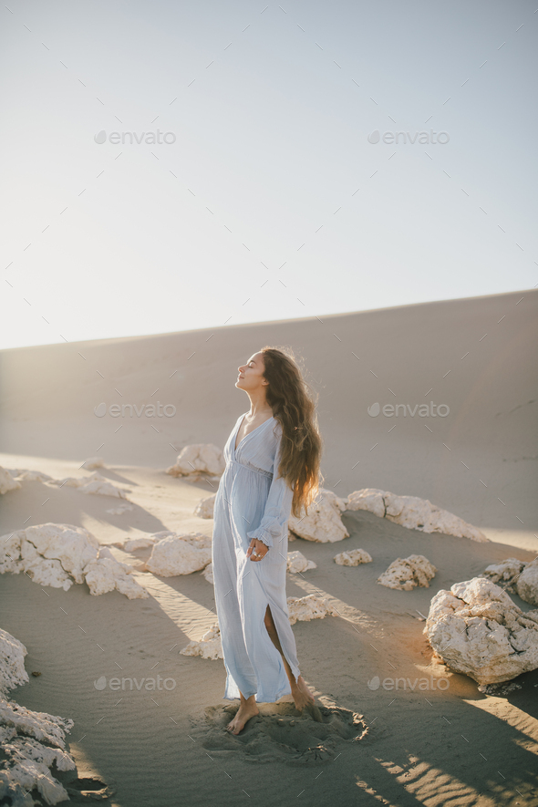 A glamorous girl in a stylish suit poses in a convertible car in the desert  and waves a silk scarf. Fashion, style, glamour Stock Photo | Adobe Stock