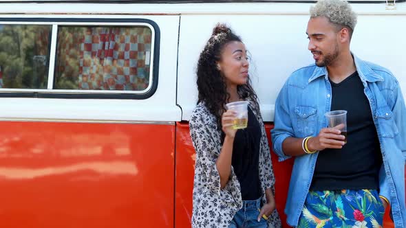 Couple interacting with each other while having glass of beer  alt