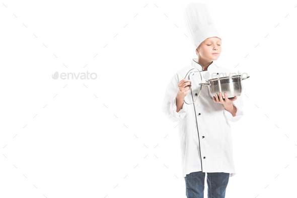 portrait of pre-adolescent boy in chef uniform with saucepan isolated on white - Stock Photo - Images