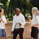Two women and black race trainer at tennis court - PhotoDune Item for Sale