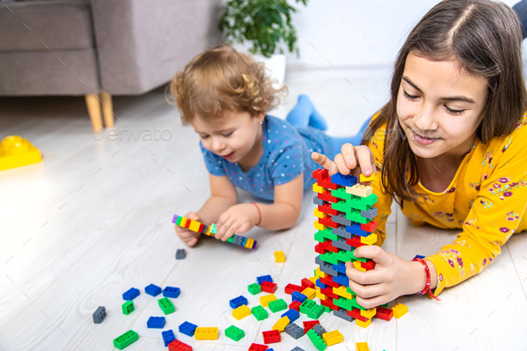 The child plays as a constructor. Selective focus. - Stock Photo - Images