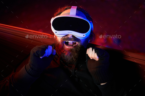 High angle view portrait of a happy man with a extended reality goggles