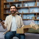 Portrait of happy online shopper at home, mature adult man smiling and looking at camera, holding - PhotoDune Item for Sale