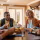 Happy senior woman talking to her friends during a lunch in residential care home. - PhotoDune Item for Sale