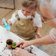 Grandmother with her grandson planting vegetables and flowers. - PhotoDune Item for Sale