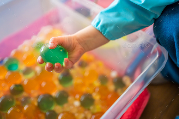 Little girl playing with sensory water beads, hydrogel balls. Sensory ...