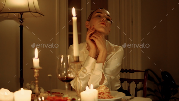 Sad lady bored alone at candles table place closeup. Upset girl waiting somebody