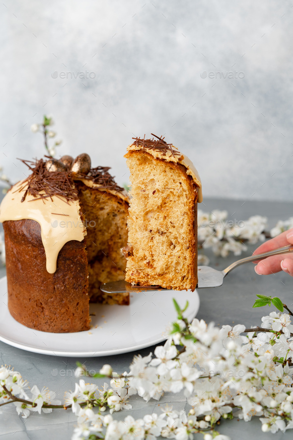 Hand holding piece of Easter cake on dessert spatula - Stock Photo - Images