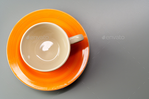 Top view of ceramic cup with saucer on gray background - Stock Photo - Images