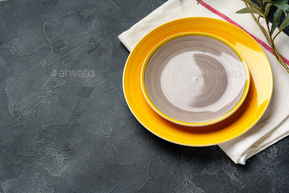 Top view of ceramic plate with table napkin on gray background - Stock Photo - Images