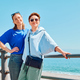 Two smiling women enjoying freedom at seaside. Female travelers relaxing in serene nature.  - PhotoDune Item for Sale