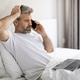 Troubled middle aged man have phone call, bedroom interior - PhotoDune Item for Sale
