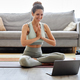 Smiling young woman using laptop in home yoga workout - PhotoDune Item for Sale