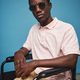 Fashionable black man with disability wearing sunglasses against blue background - PhotoDune Item for Sale