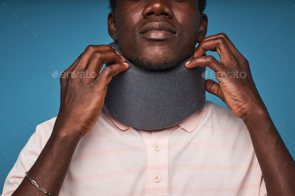 Close up of black man wearing neck brace