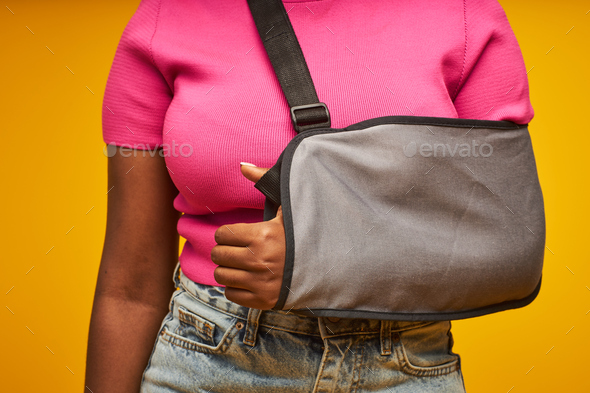 Black woman with arm sling closeup - Stock Photo - Images