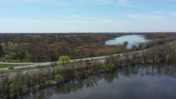 An aerial view of some reflective lakes during the day. The drone camera truck right along side the alt