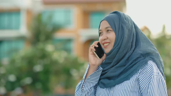 good looking Muslim women sitting outside working according to the slogan work form home
