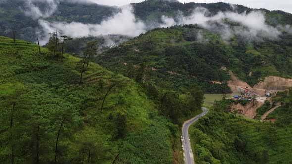 Aerial View of the Road in The Village Around Green Forests and Jungles with Palm Trees in Asia