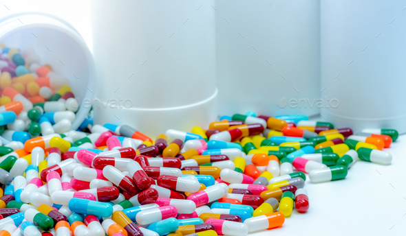 Pile of antibiotic capsule pills with plastic bottle. Antibiotic drug resistance. Antimicrobial drug
