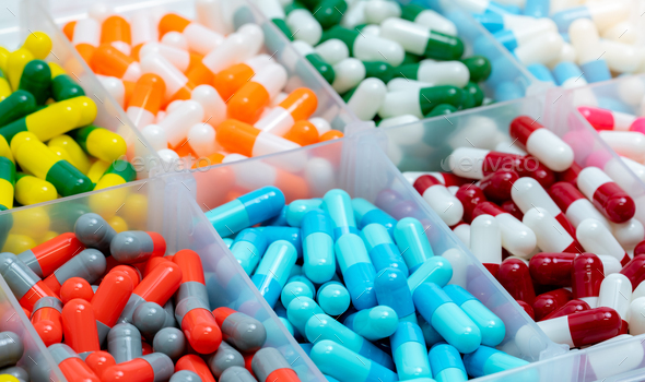 Colorful capsules pill in plastic box.  Pharmaceutical industry. Pharmacy drugstore products. Drug  - Stock Photo - Images