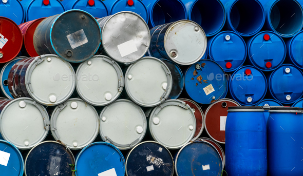 Old chemical barrels. Blue and red oil drum. Steel and plastic oil tank. Toxic waste warehouse - Stock Photo - Images