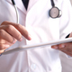 doctor in white coat is using a digital tablet - PhotoDune Item for Sale