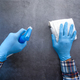 hand in blue rubber gloves holding spray bottle  - PhotoDune Item for Sale