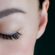 Close-up of closed eye with amazing long eyelashes, black eyeliner, perfect skin, eyebrow of - PhotoDune Item for Sale