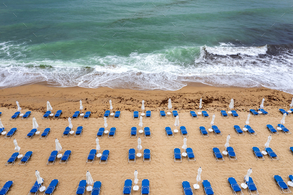 fantastic beach with, blue lounge chairs, umbrellas, and turquoise sea. - Stock Photo - Images