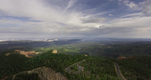 Drone view of the bend of the road with cars on the edge of the canyon (Zion National Park) alt
