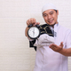 muslim man holding alarm clock, time reminder for iftar during ramadan - PhotoDune Item for Sale