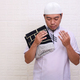 Religious Asian muslim man praying with eyes closed and opened palms  - PhotoDune Item for Sale