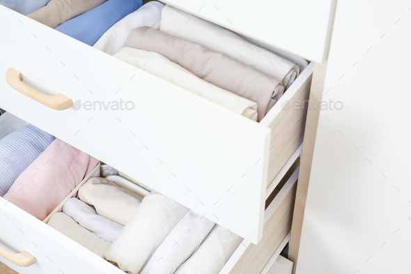 Clothes folded in a box in a dresser close-up, space organization concept.