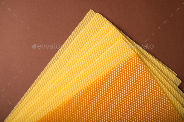 Beeswax honeycomb sheets on brown background - Stock Photo - Images